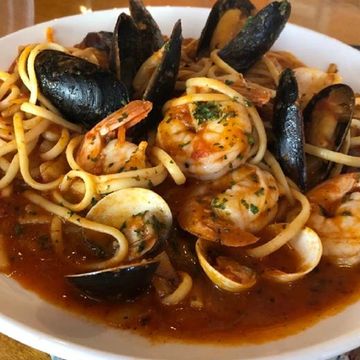 Clams, mussels and shrimp on linguini in a spicy tomato sauce