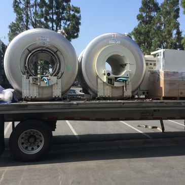 MRI magnets on flatbed truck being moved to a installation site.