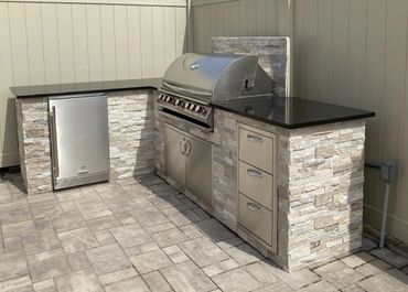 finished L-shaped stone and stainless appliances