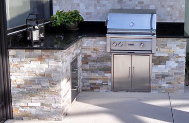 finished stone and stainless outdoor kitchen