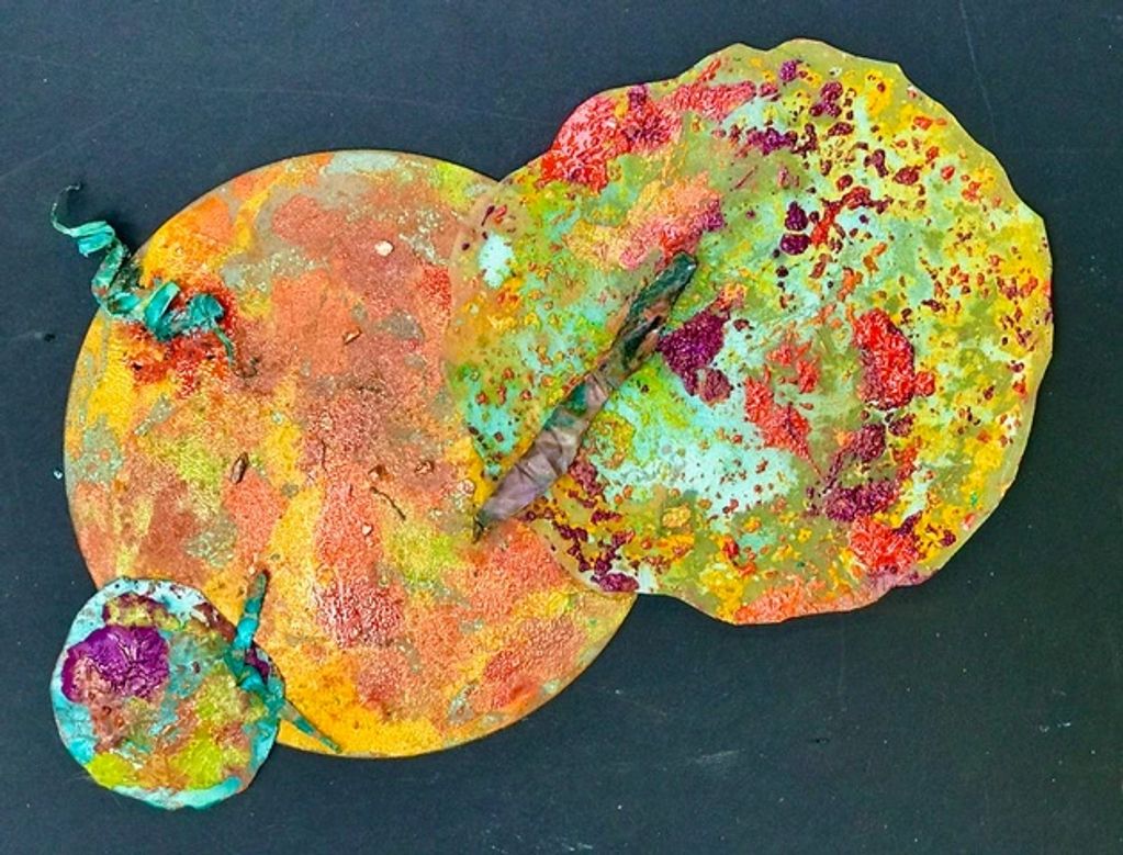 The assemblage of circles is designed with each sphere created with different mixed media.
The work