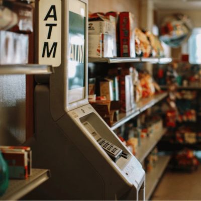 ATM machine inside a convenience store aisle.