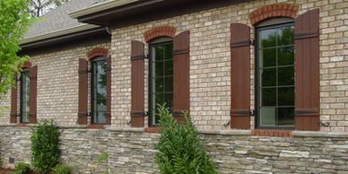 custom cedar shutters with chocolate brown stain and black hinges