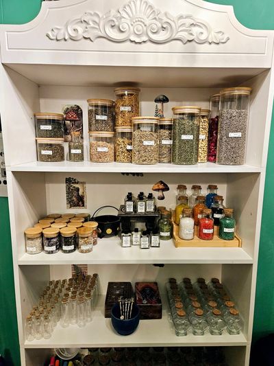 Shelf with jars and bottles of herbs and spices.
