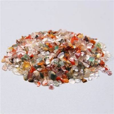 Pile of colorful small polished stones on a white surface.