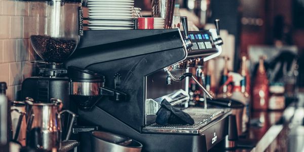 Professional espresso machine in a cozy coffee shop setting.