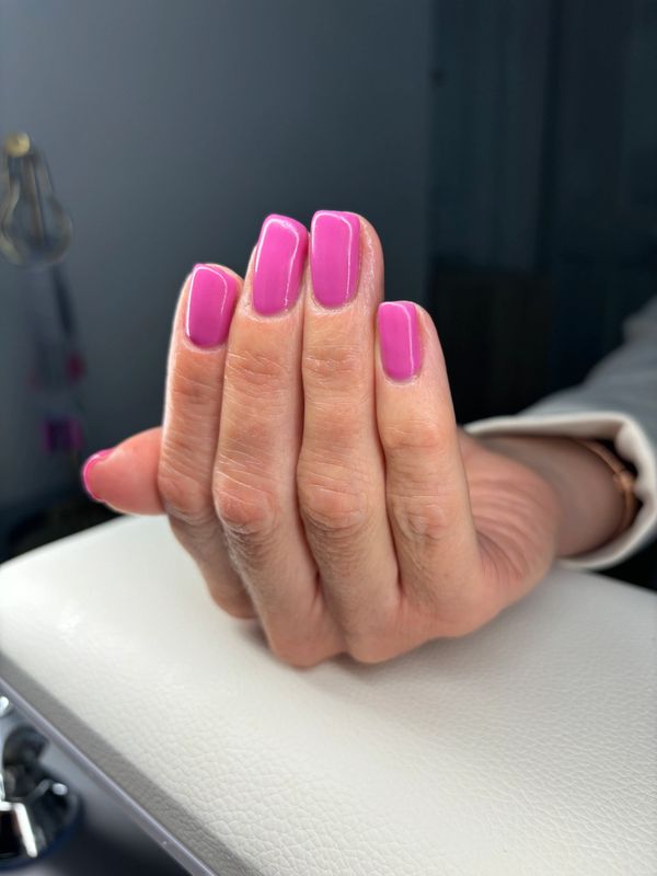 A pink square gel manicured set of nails.
