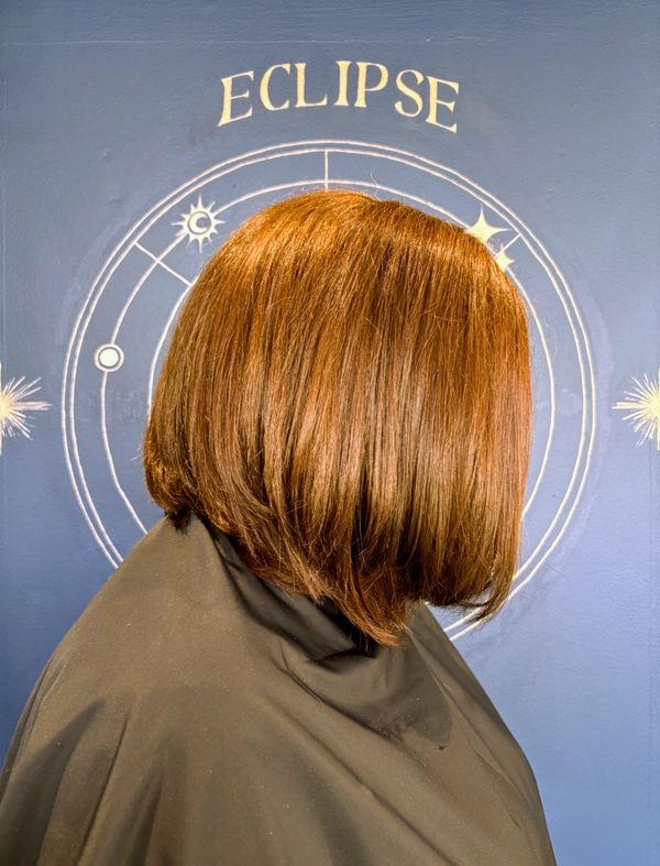Women's long bob hairstyle with warm shiny tones