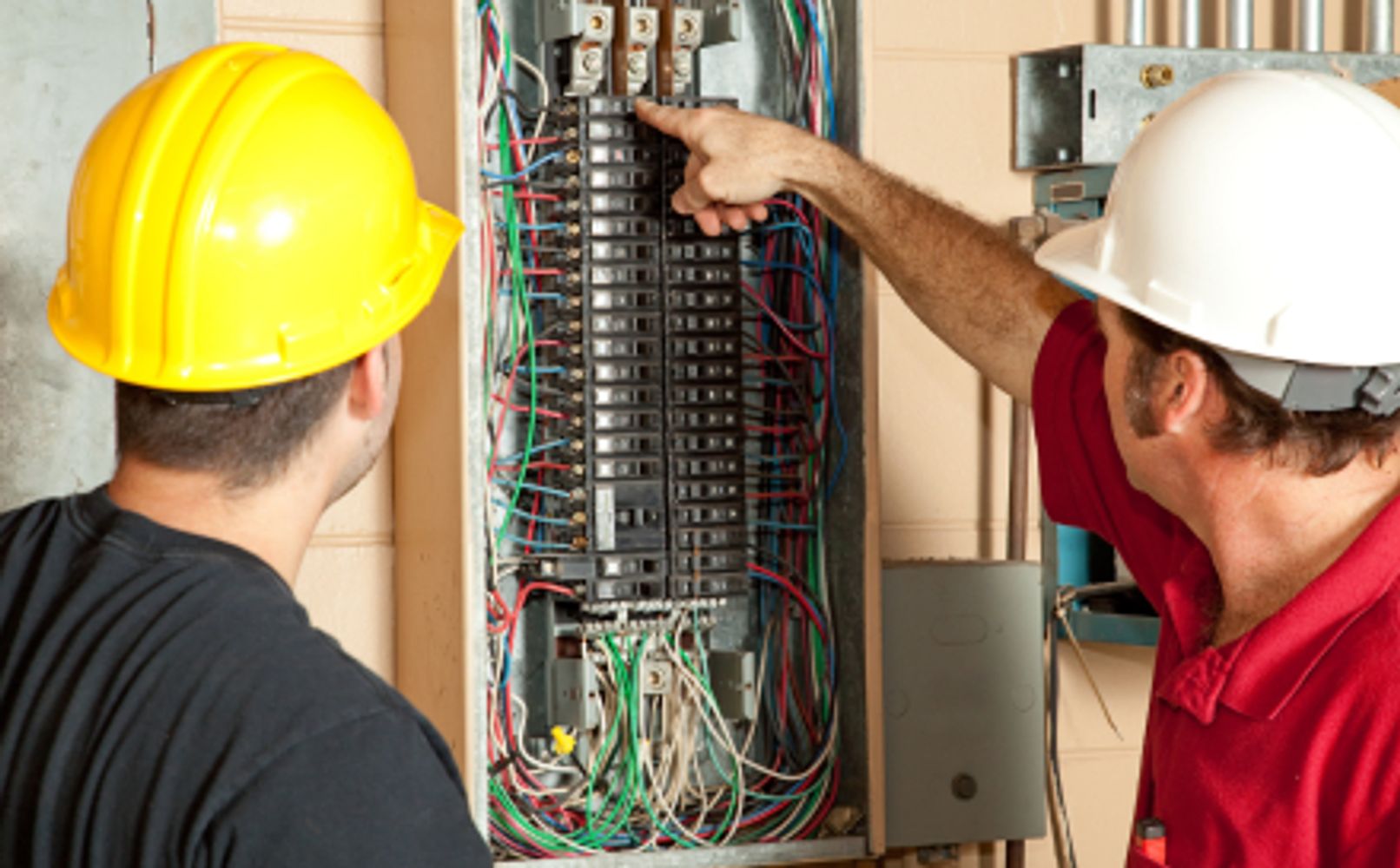 Electricians inspecting 200 amp electric panel to upgrade to 400 amp panel and determine cost.