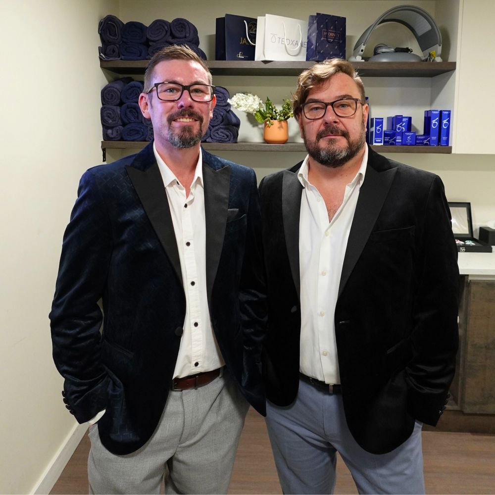 Founder & co founder perfectus Derma aesthetics standing together in smart suit jacket and trousers