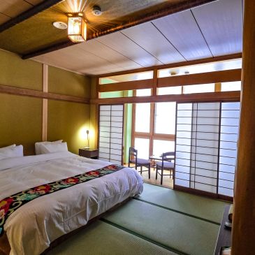 Traditional Japanese-style bedroom with tatami mats and shoji screens.