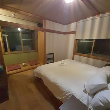 Cozy bedroom with wooden accents and a large bed.