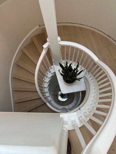 Modern interior Spiral staircase viewed form above, creating a cercular, almost sculptural pattern.