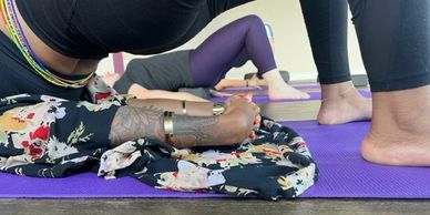 Students practicing Setu Bandha Sarvangasana during a Yin Yoga class.