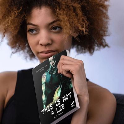 A young woman deep in thought as she holds a copy of the novel titled This is Not a Lie.