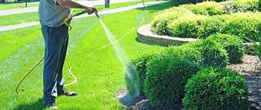 Perforated drainage pipe installed in a gravel-lined yard trench.
