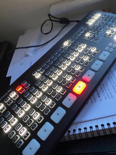 Close-up of a lit control panel with numerous buttons and numbered keys.