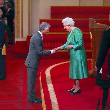 Dr Henry Muttoo being awarded the MBE