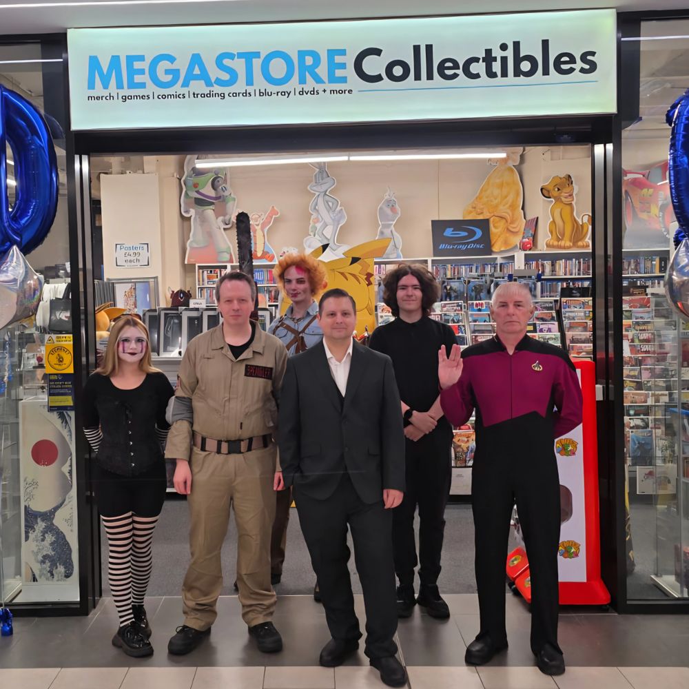 Group of six people in costumes standing in front of a collectibles store.