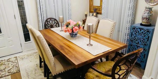 Elegant dining room with wooden table and floral centerpiece.
