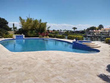 Glass bead surface, fountain addition, sun shelf, new tile and travertine deck.