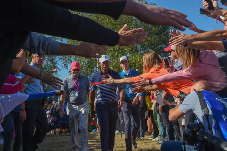 Golf fans flock around Tiger Woods as he makes his way to the 3rd tee during the 2018 Ryder Cup in Paris, France.