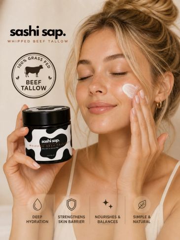 Woman applies Sashi Sap whipped beef tallow cream for skin care.