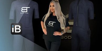 Woman modeling a black Body Time EMS suit with long blonde hair and confident pose.