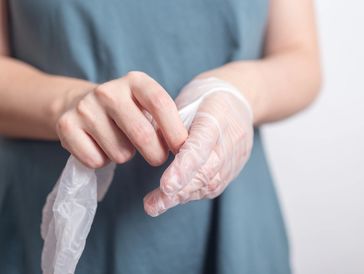 Cleaner wearing disposable gloves