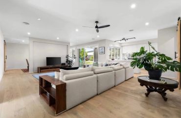 Spacious modern living room with beige sectional sofa.
