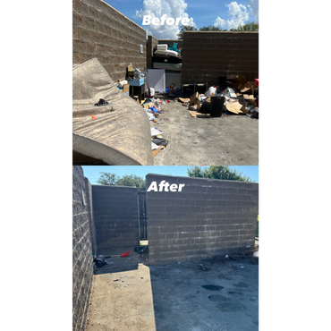 A rusty yellow dumpster filled with broken bricks and rubble.