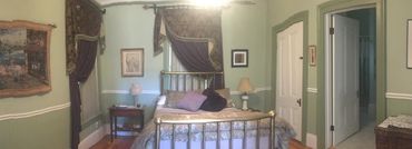 Cozy guest room featuring queen bed and accessible step-in shower