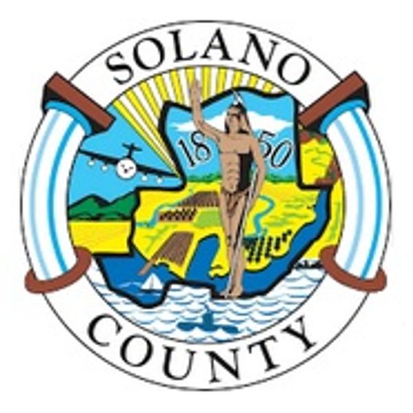 Seal of Solano County with a Native American figure and landscape.