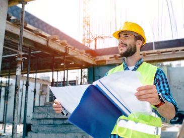 Construction worker reviewing the WIP report