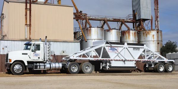 Large industrial truck with a tanker trailer.