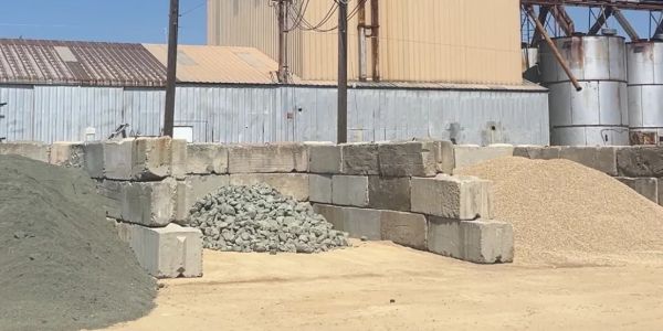 Construction materials stored outdoors in separate piles.
