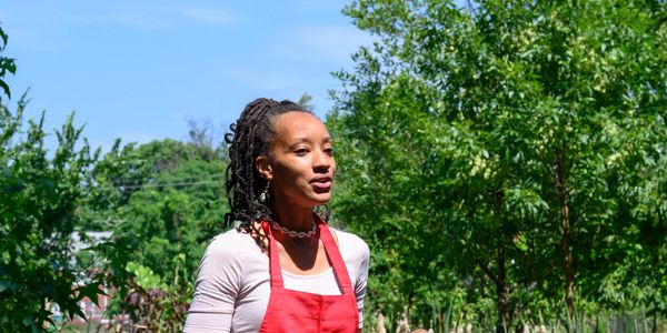 A woman standing in sun light