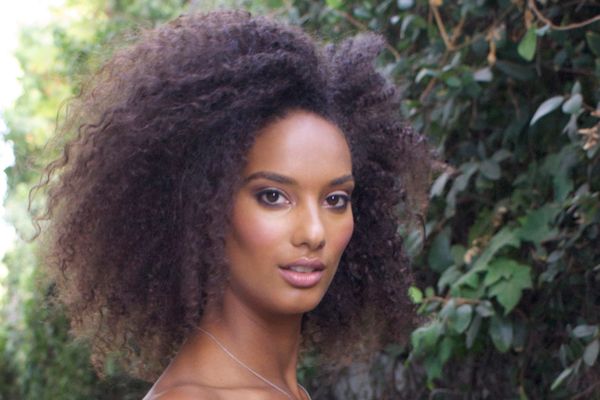 A woman with big hair posing for the camera.