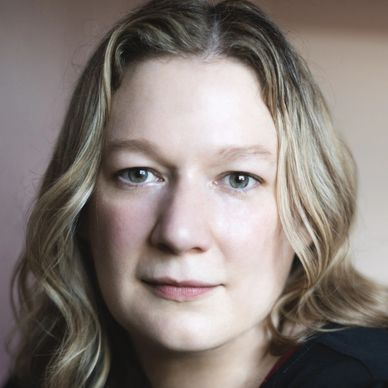 Holly Gramazio looks straight on at the camera with a soft smile