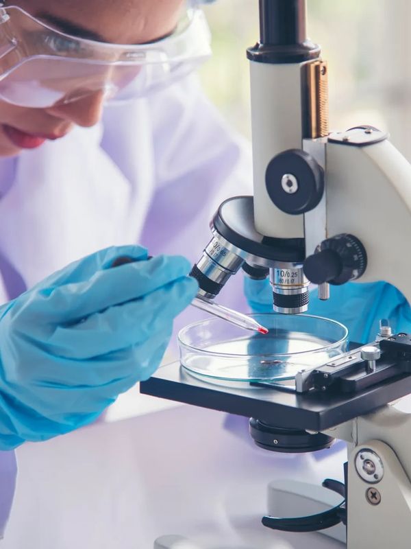 A female Scientist working with microscope