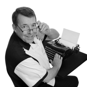 Magician Roger "Skip" Way, also known as Happy Dan is pictured here with a typewriter.