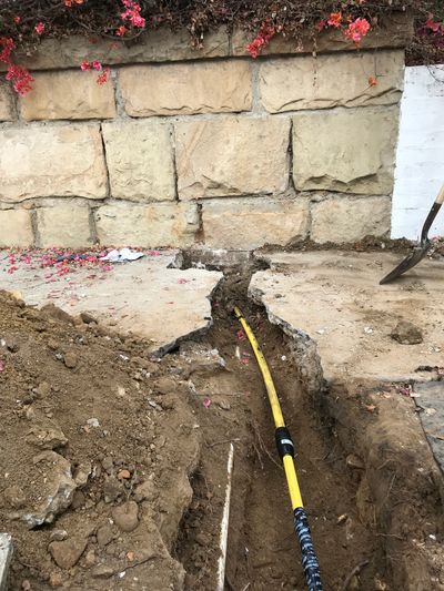 rotted out gas line replaced from street, under wall, through yard to side of house  - in a day