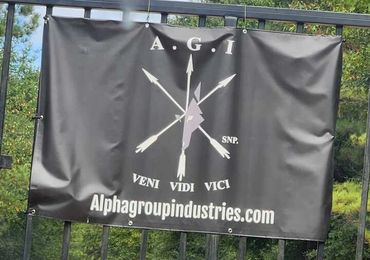 Black banner with arrows and text promoting Alphagroupindustries.com.