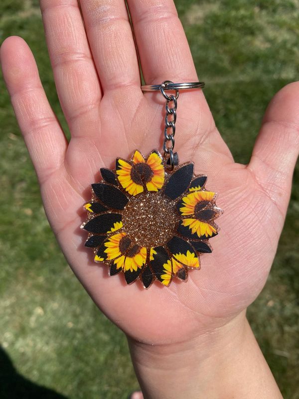 This cute sunflower is a 2 inch acrylic  key chain sealed with resin for durability.