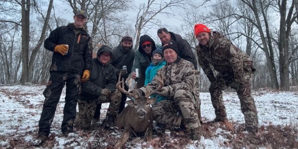 Mike's 2025 buck and the congratulatory group!
