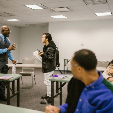 Teacher and student arguing in classroom.