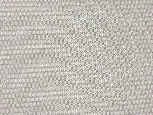 Close-up of clear bubble wrap with tightly packed air bubbles.