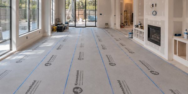 Room under construction with protective floor covering.