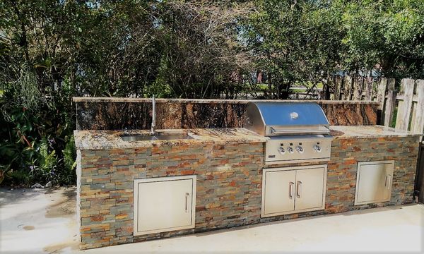 outdoor kitchen with Broil master grill, single doors.