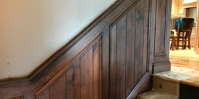 Paint Vail crew gel stained this wood paneling to match the other trim in this house on the Vail gol